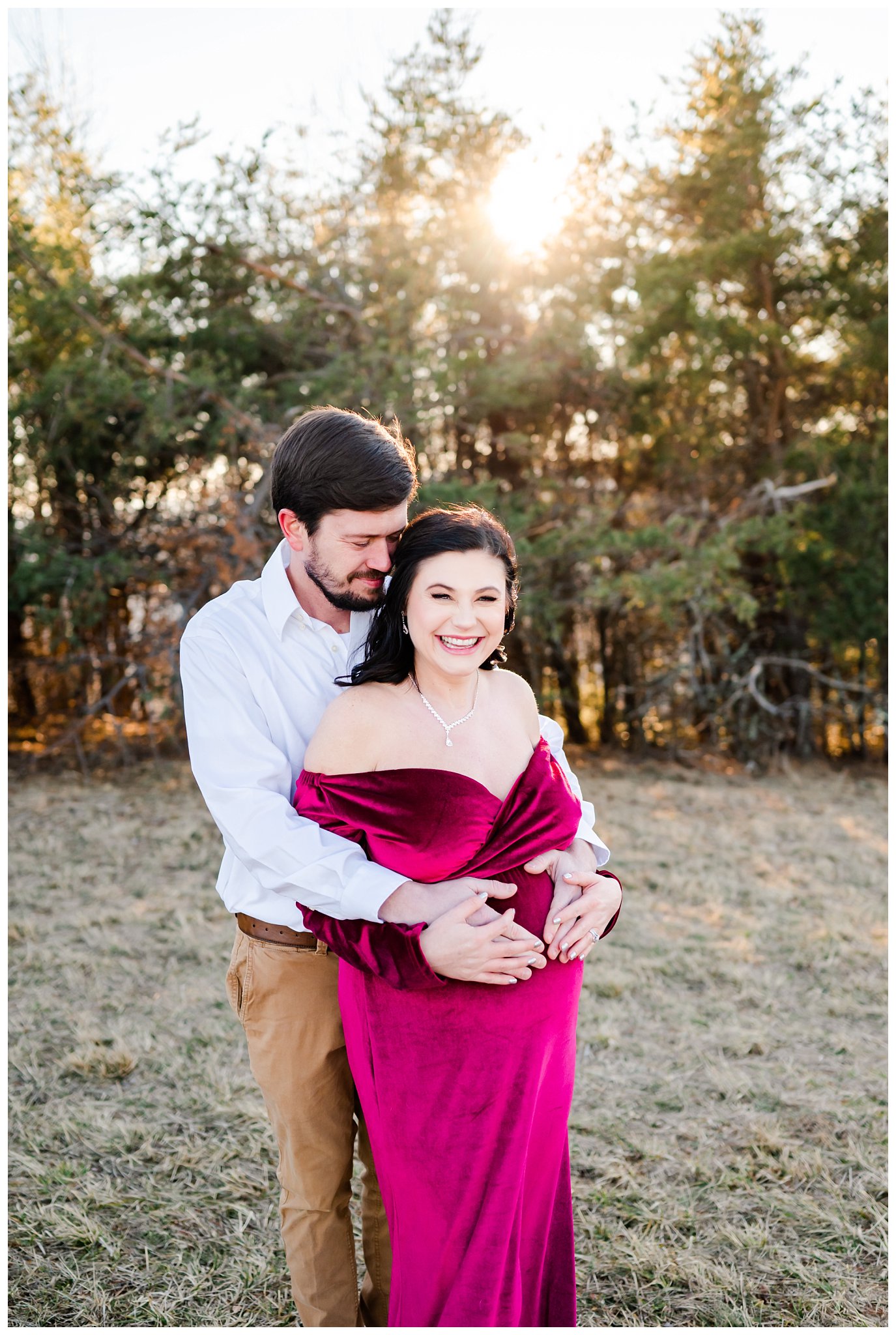 couple laughing outdoors for their winter maternity session