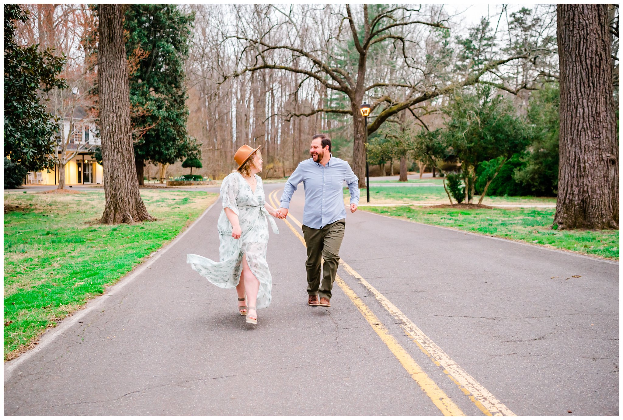 couple running in a road laughing for their engagement session
