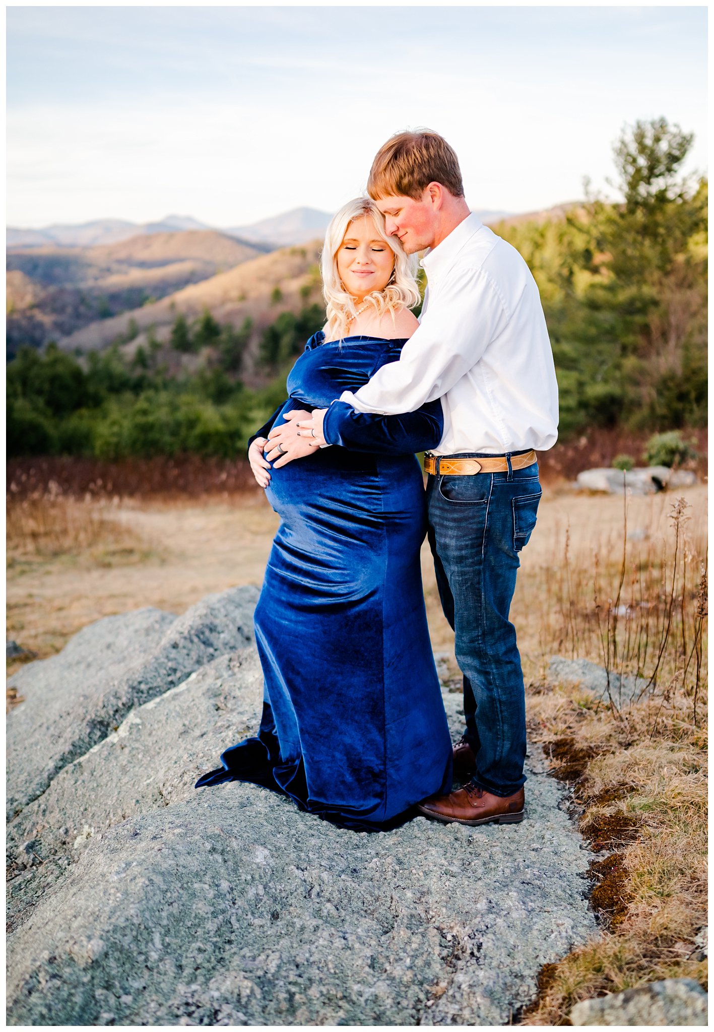 couple snuggling for mountain maternity session