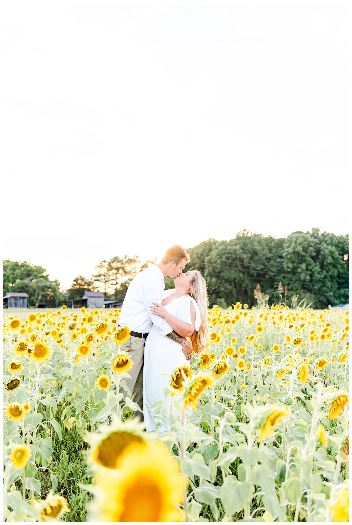 couple in sunflower field for summer engagement session