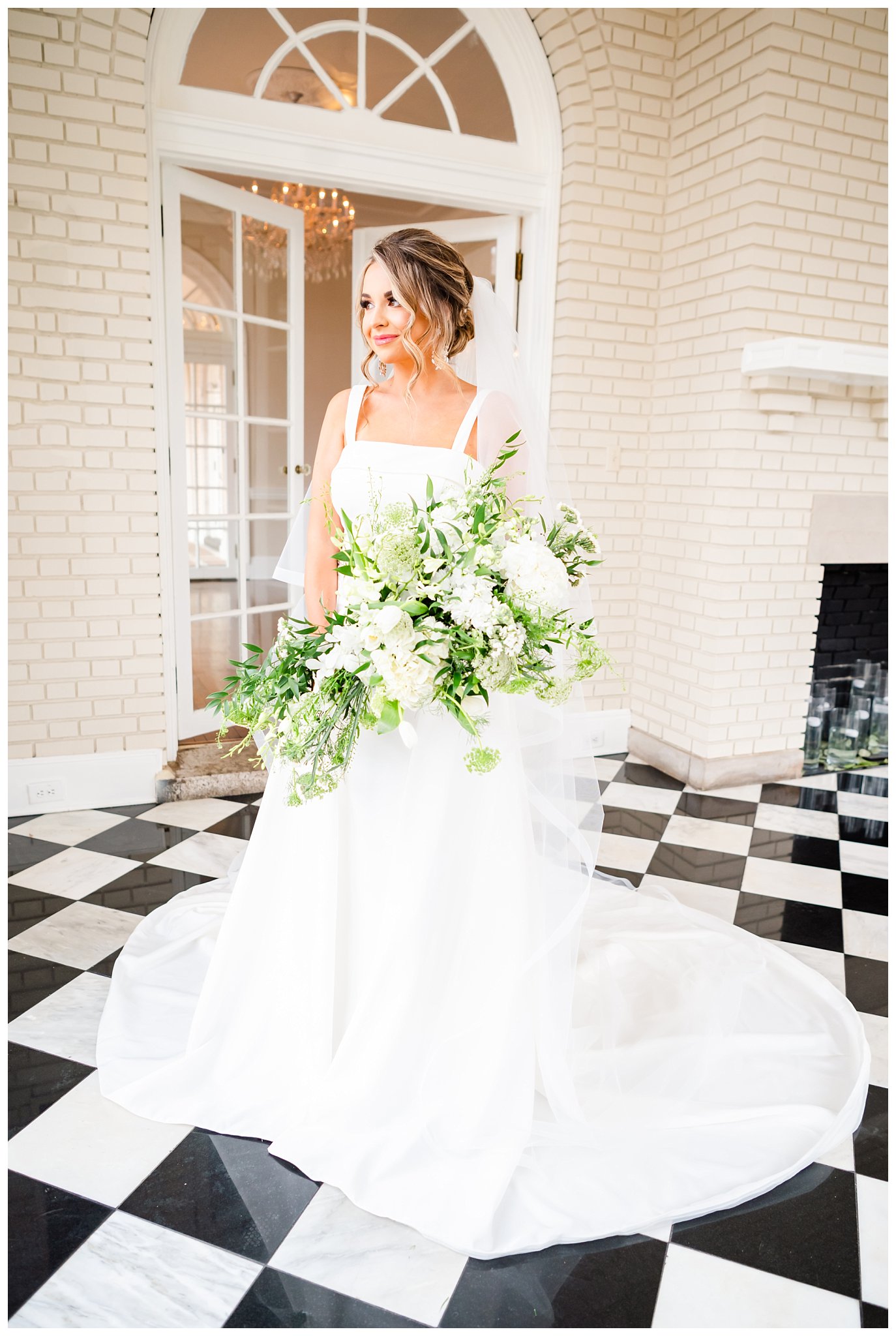 bride poses with large bouquet for her bridal portraits