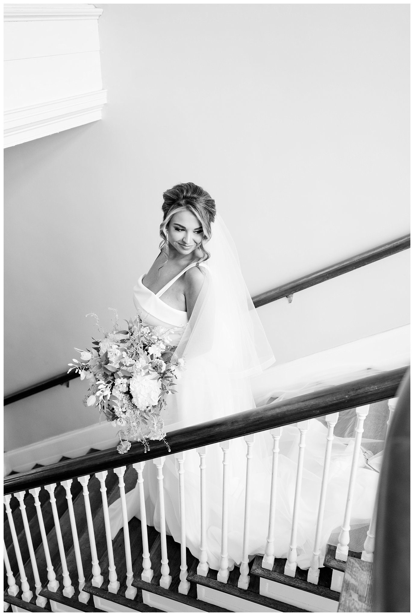 black and white photo of bride on staircase