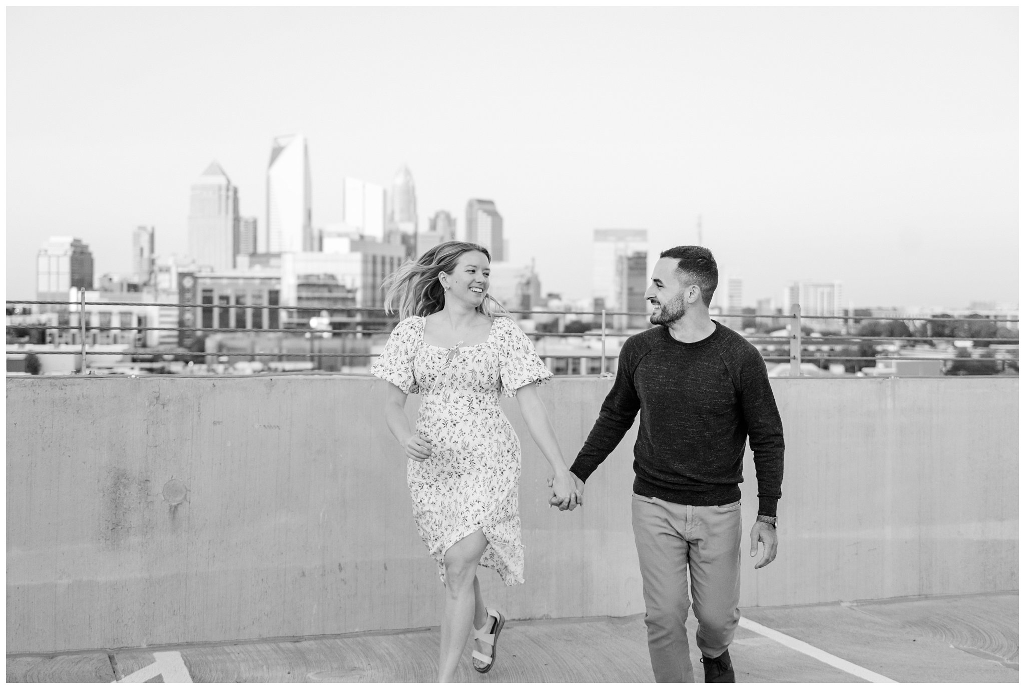 black and white rooftop photo of couple for their downtown Charlotte engagement session