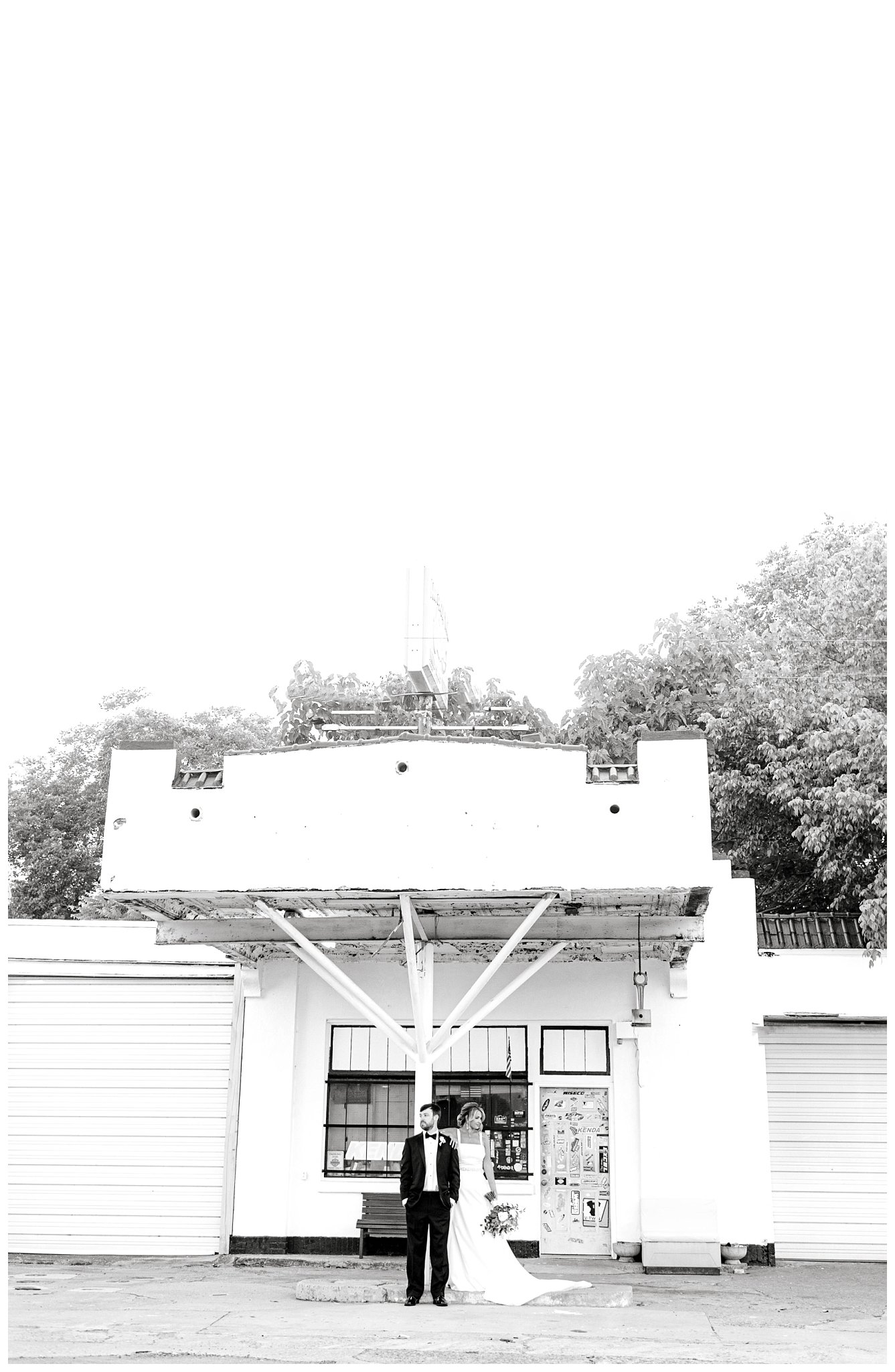 black and white photo of couple posing in front of old gas station for their North Carolina summer wedding