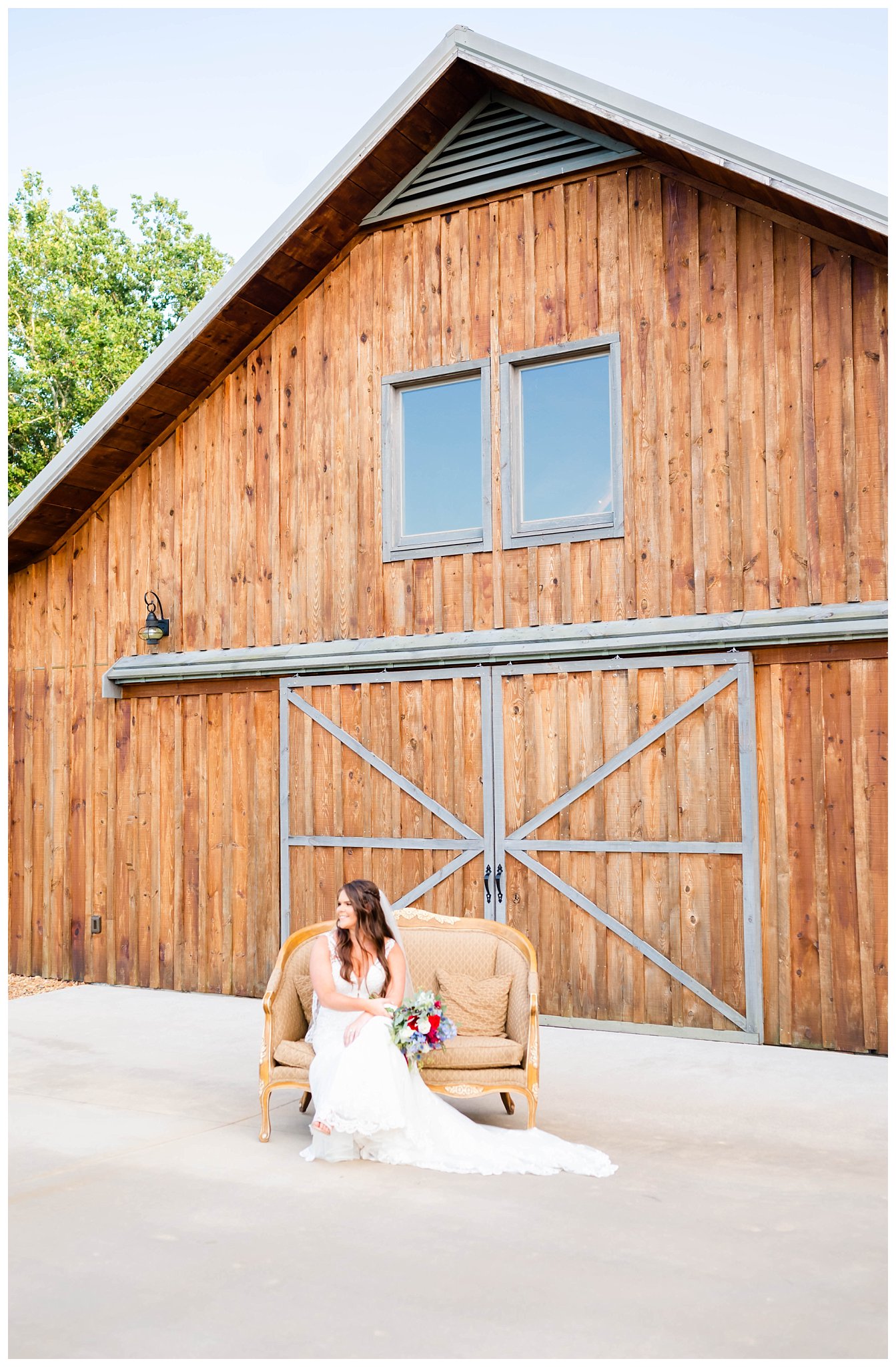 Nicole posing in front of barn for her rustic bridal portraits