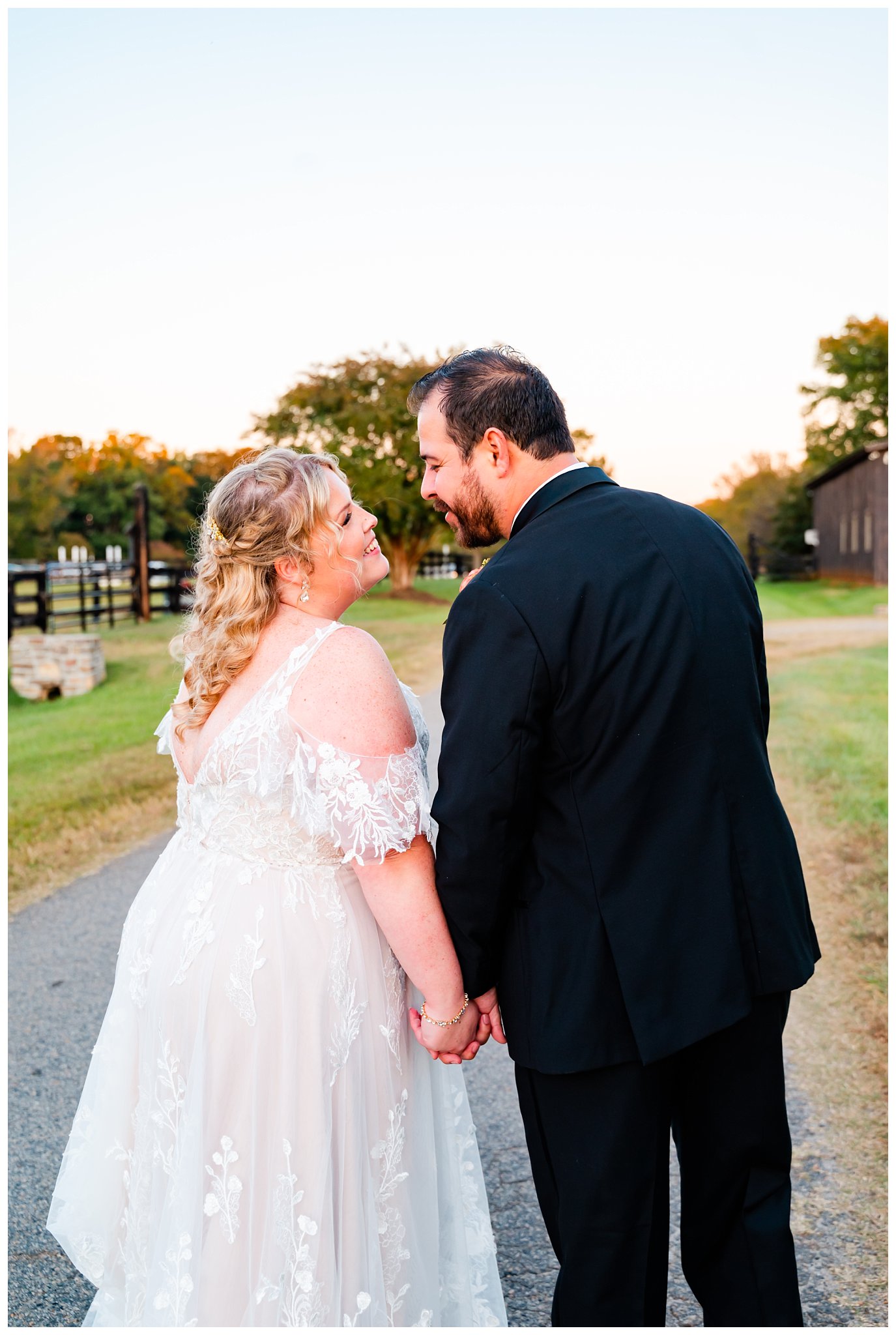 bride and groom pose for portrait at their equestrian farm wedding